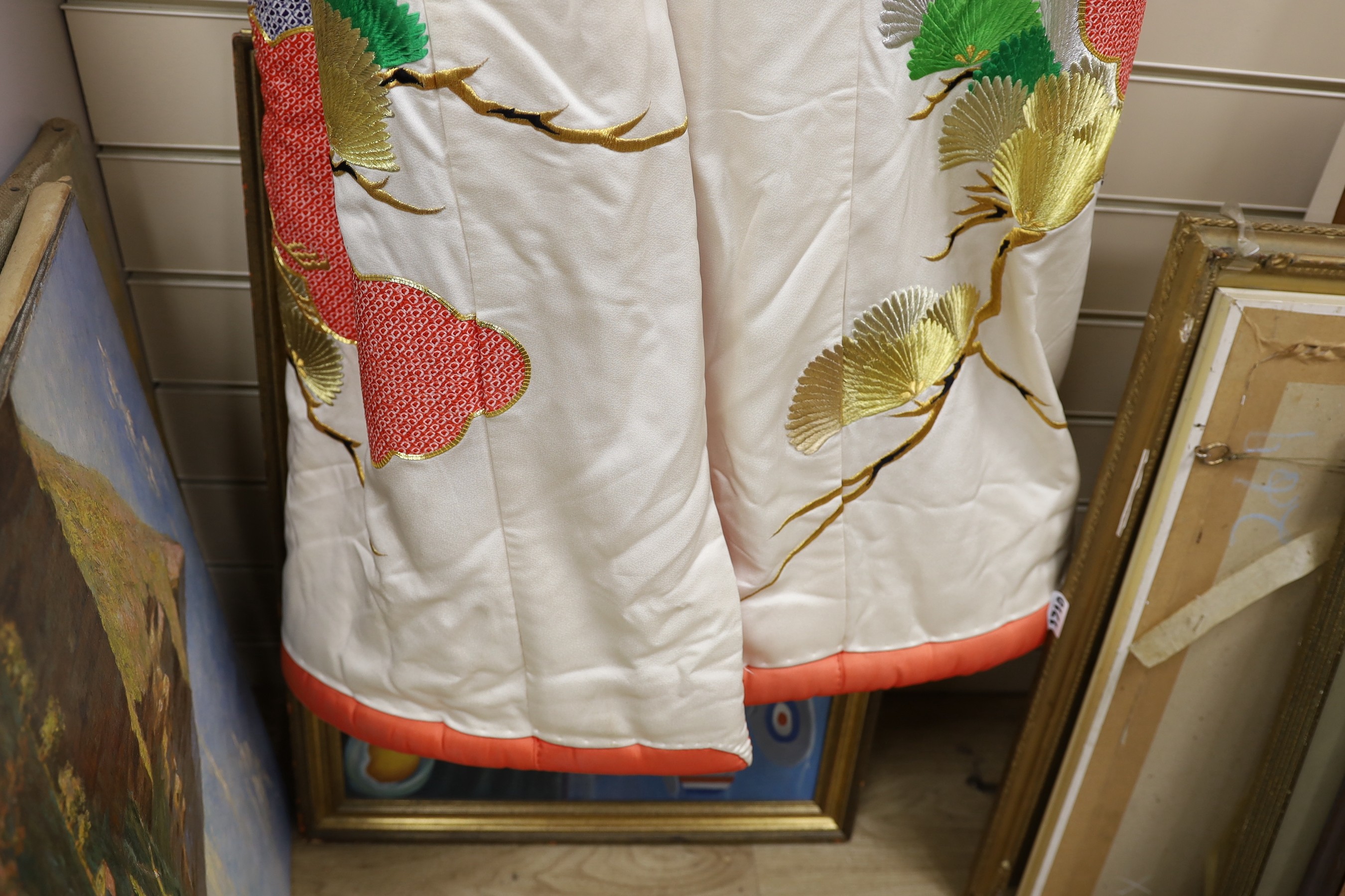 A Japanese cream ground ceremonial kimono, embroidered with coloured silks and metallic embroidery, in an all over design, with flame red silk lining
